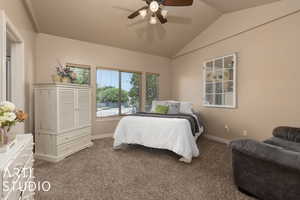 Bedroom featuring lofted ceiling, carpet floors, and ceiling fan