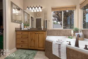 Bathroom with tile patterned flooring, vanity, and tiled tub