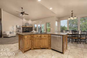 Kitchen featuring sink, decorative light fixtures, a center island, and dishwasher