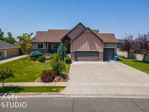 Craftsman inspired home with a garage and a front yard