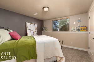 Bedroom featuring carpet floors and a textured ceiling