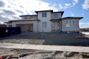 Prairie-style home featuring a garage