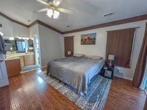 Primary Bedroom with wood-type flooring, connected bathroom, a textured ceiling, and ceiling fan