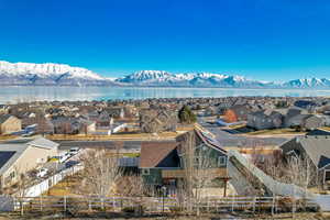 Birds eye view of property with a water and mountain view