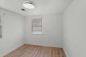 Spare room with light hardwood / wood-style floors