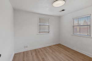 Empty room featuring light wood-type flooring