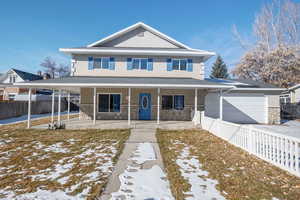 View of front of house with a porch and a garage