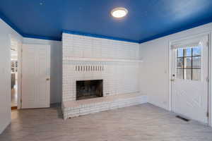 Main. floor Bedroom/Office featuring a brick fireplace