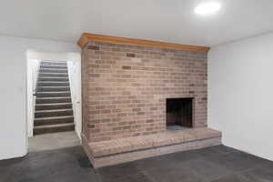 Basement Family Room featuring a fireplace and a basement. entrance