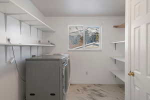 Upstairs Laundry room with washing machine and clothes dryer