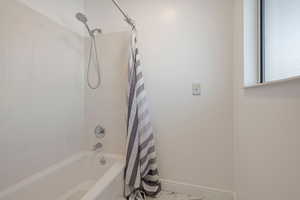 Bathroom featuring shower / bath combo with shower curtain