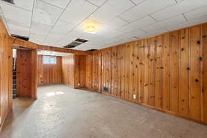 Basement featuring wooden walls