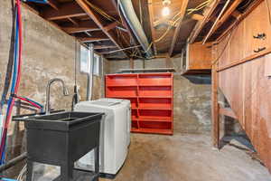 Basement featuring sink and washer and clothes dryer