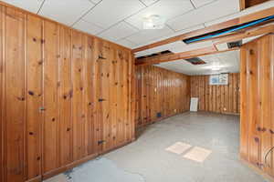 Basement featuring wood walls