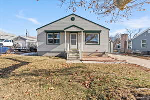 Bungalow-style house featuring central AC and a front yard