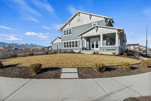 Exterior space featuring a mountain view, a yard, and french doors