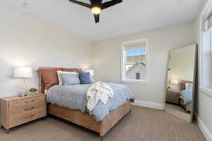 Bedroom featuring light colored carpet and ceiling fan