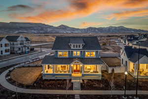 Back house at dusk featuring a mountain view