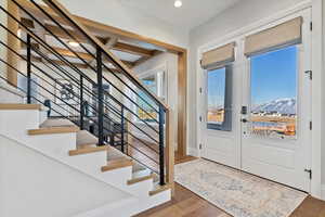 Foyer entrance with a mountain view and wood-flooring