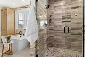 Primary Bathroom with walk in shower with separate freestanding  bathtub and tile walls