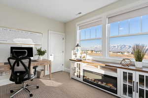 Home office with a mountain view and carpet