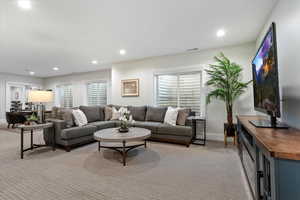 Living room featuring light carpet