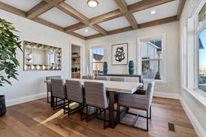 Formal Dining space featuring beamed ceiling, coffered ceiling, dark hardwood / wood-style floors, and built in shelves