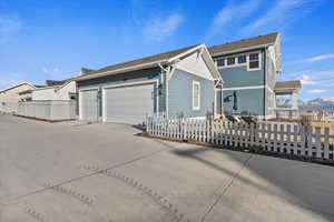 View of front of property featuring a 3 car garage and a mountain view