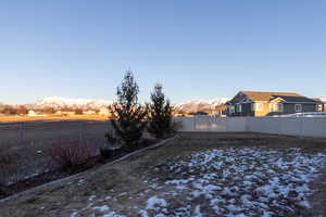 Yard at dusk featuring a mountain view