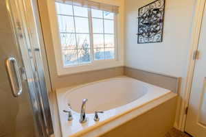 Master bathroom with walk in shower and bathtub