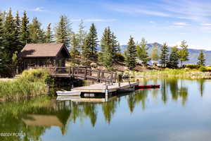 View of dock featuring a water and mountain view