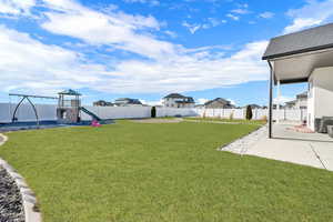 View of yard featuring a patio and a playground