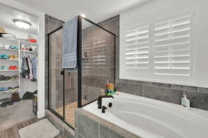 Bathroom featuring wood-type flooring and separate shower and tub