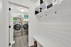 Laundry room with light hardwood / wood-style flooring and independent washer and dryer