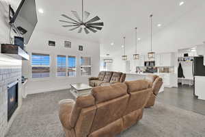 Living room featuring dark wood-type flooring, ceiling fan, and sink