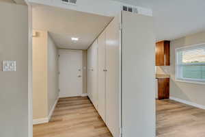 Hallway with light wood-type flooring