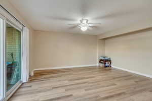 Empty room featuring ceiling fan and light hardwood / wood-style flooring