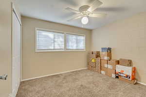 Interior space with brick wall, ceiling fan, and a closet