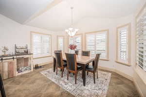 Dining area featuring lofted ceiling and an inviting chandelier