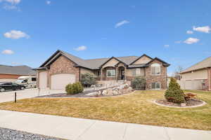 View of front of home with a garage and a front yard