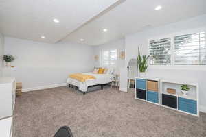 Bedroom featuring carpet floors and a textured ceiling