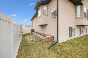 Exterior space featuring a yard and central AC unit