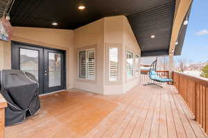 Wooden deck featuring area for grilling