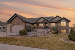 View of front of house featuring a garage and a lawn