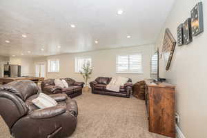 Living room with light carpet and a textured ceiling