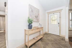 Entrance foyer featuring vaulted ceiling