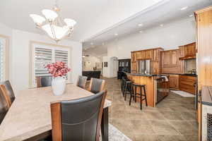 Dining room featuring high vaulted ceiling and a notable chandelier