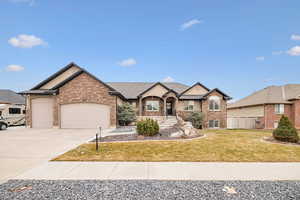 View of front of house with a garage and a front lawn