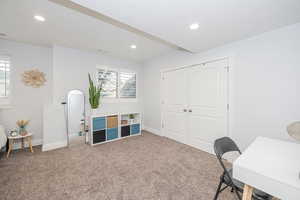 Home office with plenty of natural light, carpet, and a textured ceiling