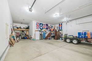 Garage featuring a garage door opener and a workshop area